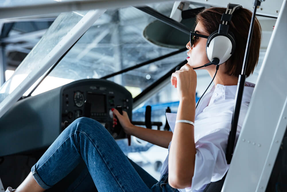 woman pilot sitting and talking with headset